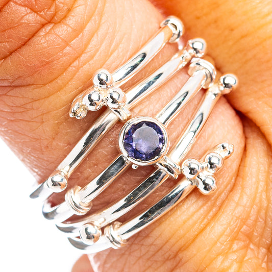 Sterling silver ring with round blue-purple gemstone and small cross accents