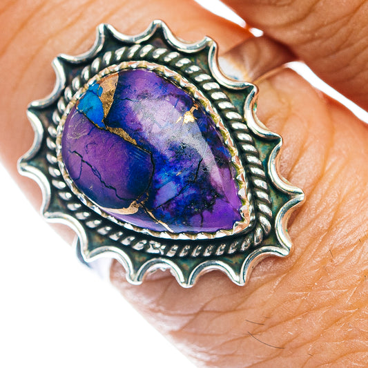 Sterling silver ring with oval purple-blue stone in scalloped sunburst bezel