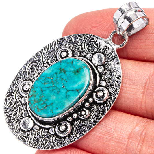 German silver turquoise oval pendant with ornate border and metal loop bail