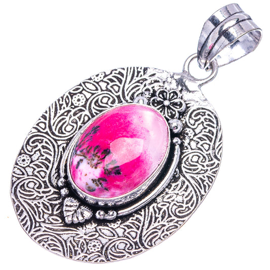 German silver oval pendant with ornate swirling filigree and pink opal cabochon