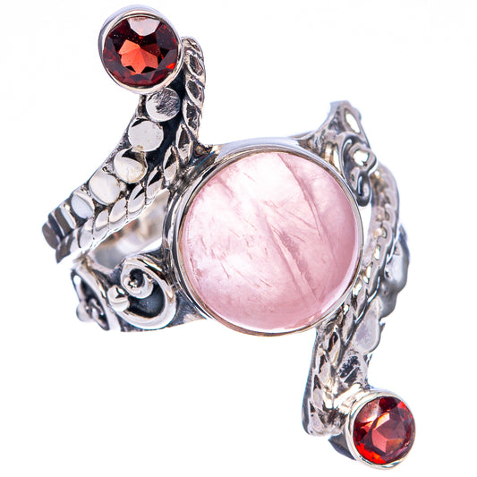 Sterling silver cuff-style ring with oval rose quartz center and round red gemstones