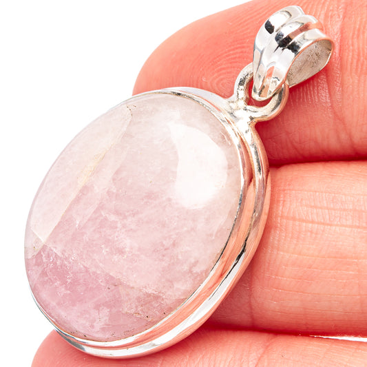 Oval pink kunzite pendant, sterling silver bezel with clasp bail, shown on finger