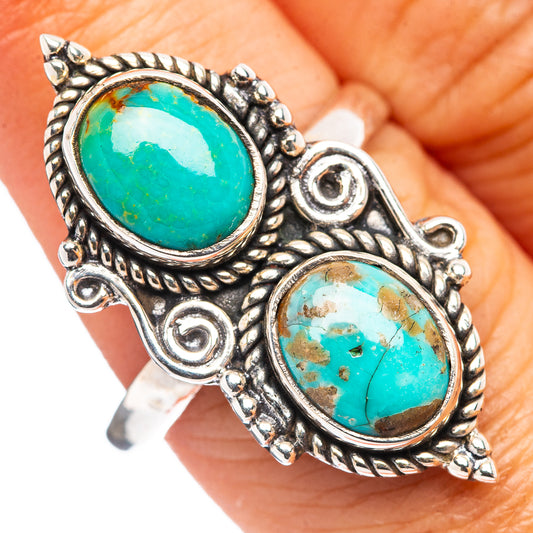 Adjustable sterling silver ring with two oval turquoise cabochon stones, ornate border