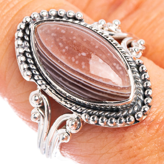 Sterling silver ring with oval Botswana agate cabochon and beaded bezel