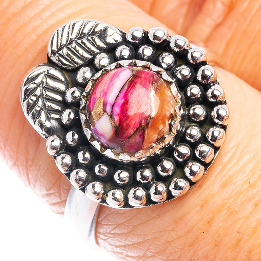 Sterling silver ring with oval pink cabochon and bead and leaf detailed setting
