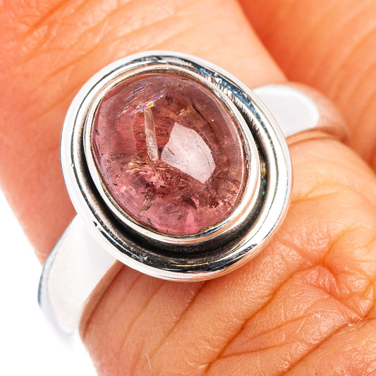 Sterling silver ring with oval pink tourmaline, close-up on finger