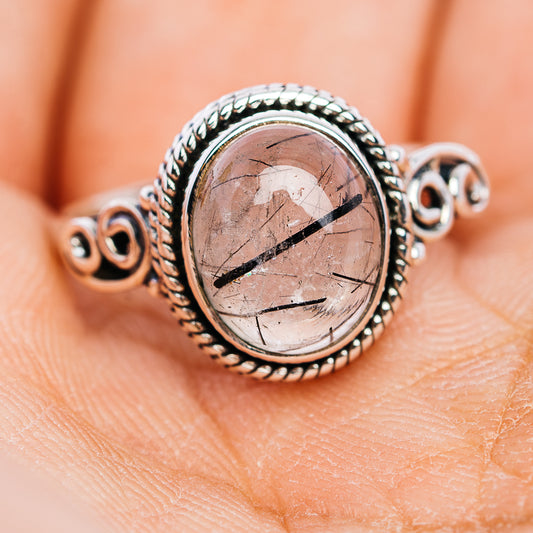 Sterling silver oval stone ring with beaded frame and swirling side mounts