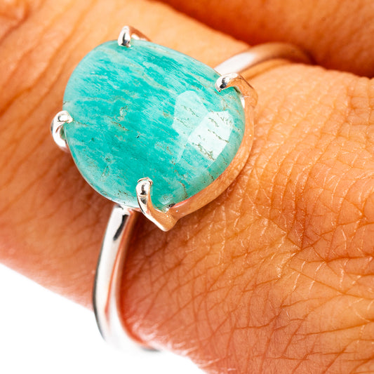Sterling silver ring with large oval teal gemstone, shown on hand