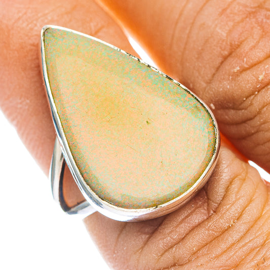 Sterling silver teardrop opal ring with bezel setting, pearlescent yellow-green center