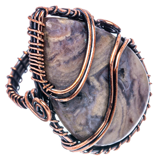 Oxidized copper wire-wrap ring with oval stone, braided band and double curved copper frames