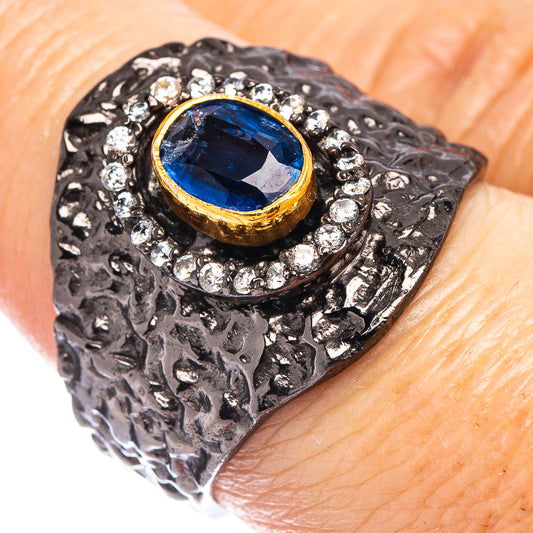 Black rhodium silver ring with blue gemstone center and diamond halo, size 7.75