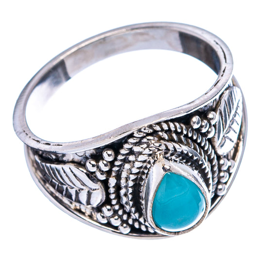 Sterling silver cocktail ring with blue teardrop gemstone and leaf-like engraved band
