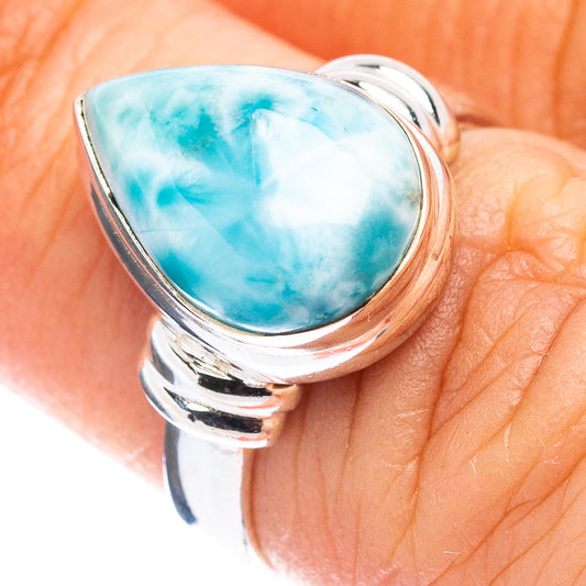 Sterling silver larimar ring with oval sky-blue stone, close-up on finger