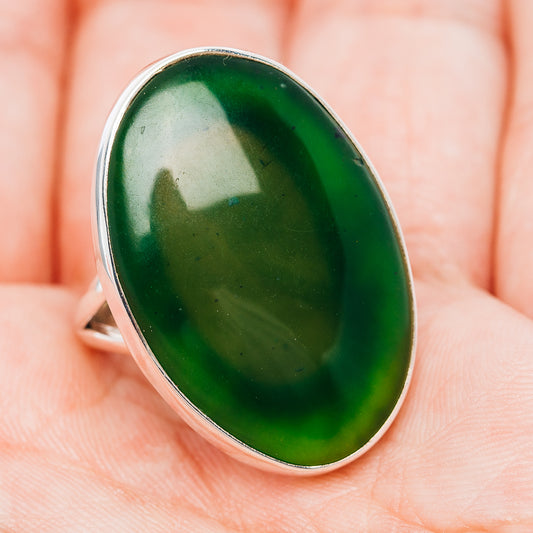 Oval green nephrite jade ring in .925 sterling silver, angled close-up