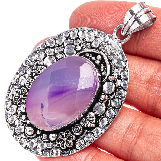Purple oval agate pendant with ornate silver-tone bezel and top bail clasp