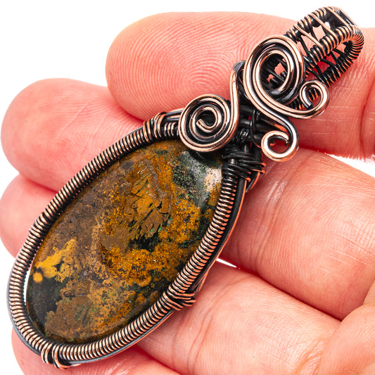 Oxidized copper wire wrap pendant with oval green-and-yellow agate and spiral links