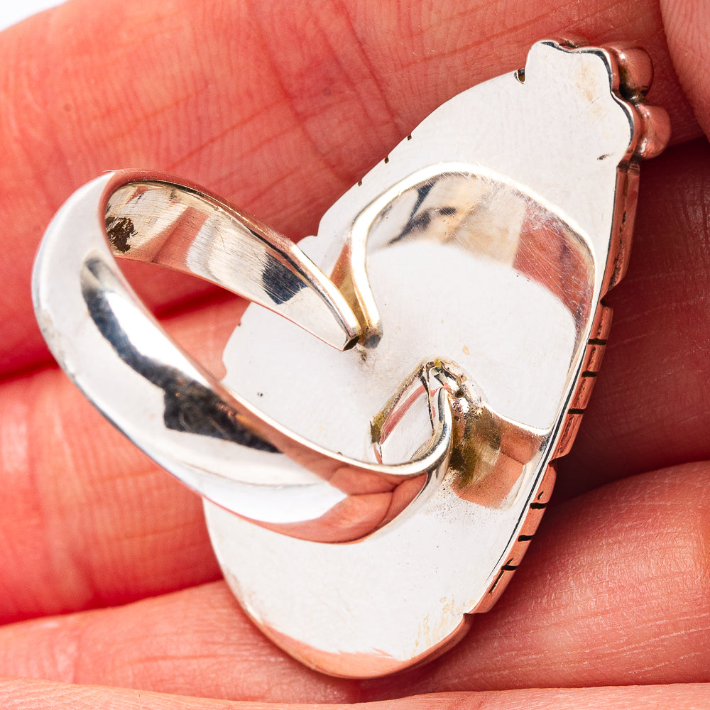 Adjustable silver ring with open heart setting and smooth metal interior close-up