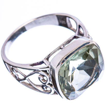 Sterling silver ring with oval faceted green gemstone and ornate filigree band