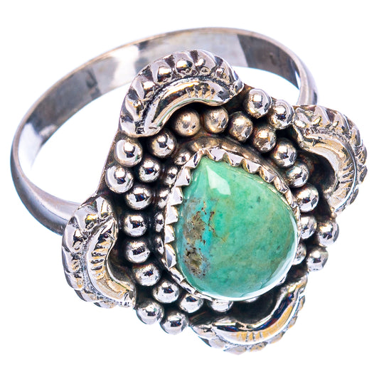 Sterling silver ring with oval turquoise cabochon, scrollwork and raised bead bezel