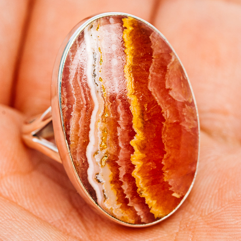 Sterling silver rhodochrosite ring, oval bezel-set cabochon with red and white stripes.