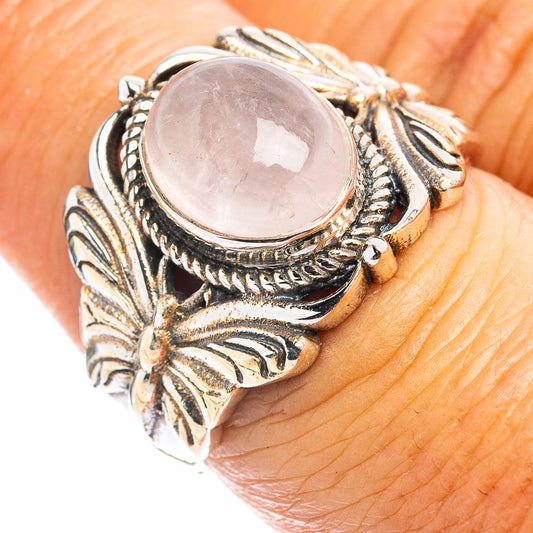 Rose quartz butterfly ring with oval pink stone and ornate silver-tone filigree band