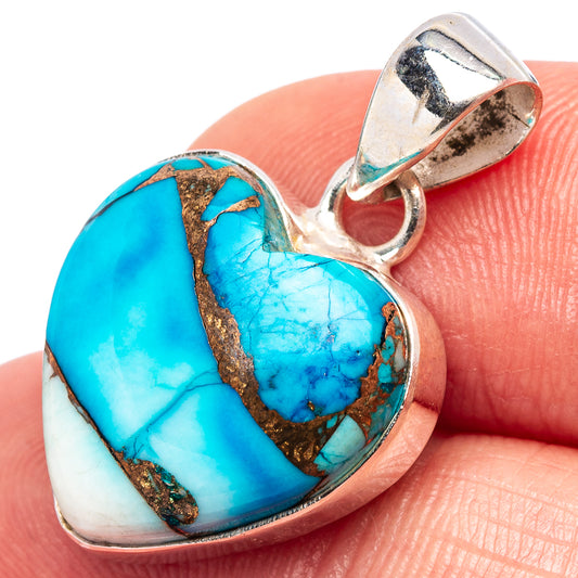 Sterling silver heart pendant closeup, blue turquoise inlay with gold-toned matrix