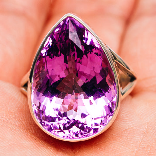 Faceted amethyst teardrop ring in sterling silver, angled side view showing setting
