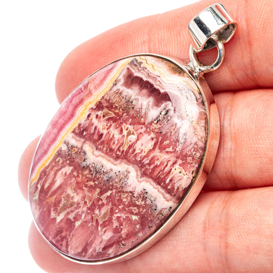 Oval pink-and-white rhodochrosite pendant with sterling silver bail