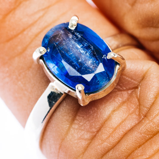 Faceted kyanite sterling silver ring with blue gemstone, oval cut, side prongs