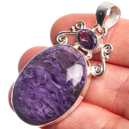 Sterling silver pendant with large oval purple cabochon and small amethyst drop charm