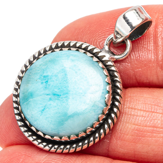 Sterling silver Larimar pendant with round blue-green stone and braided bezel edge