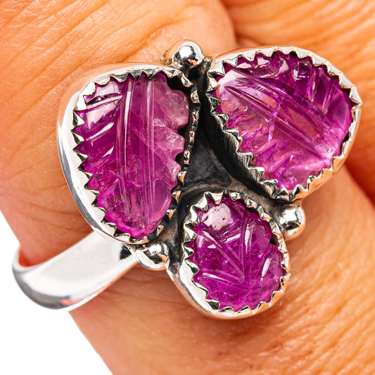 Sterling silver ring with three purple carved gemstone teardrops, scrolled setting