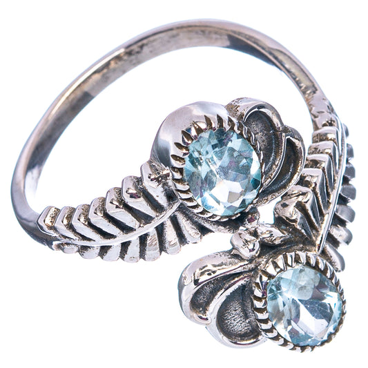 Sterling silver ring with two oval faceted light blue gemstones and ornate split shoulders