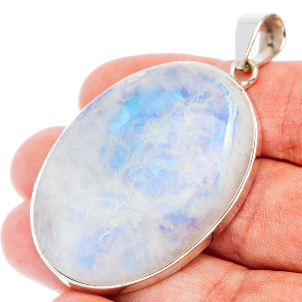 Sterling silver rainbow moonstone pendant with oval opal-like cabochon and round bail