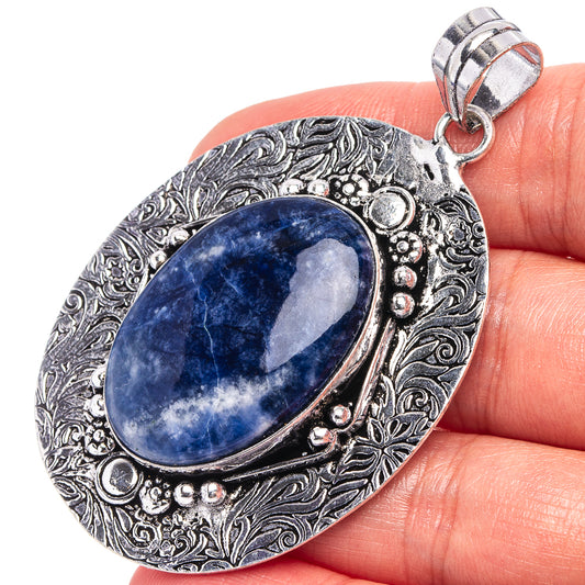 Sodalite pendant with oval blue stone in ornate German silver setting and hanging bail
