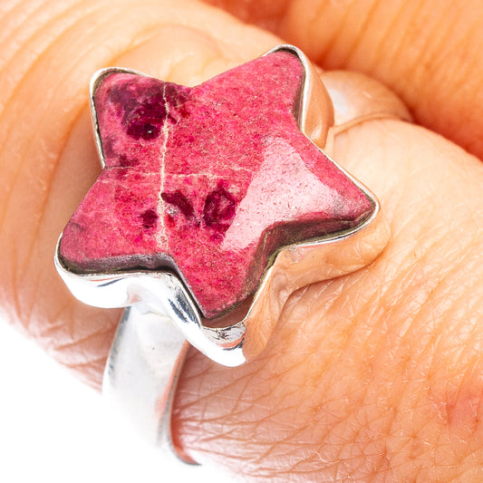 Sterling silver star ring with star-shaped red gemstone close-up