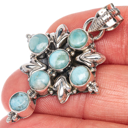 Blue-green larimar cabochon cross pendant in sterling silver, close-up on bail
