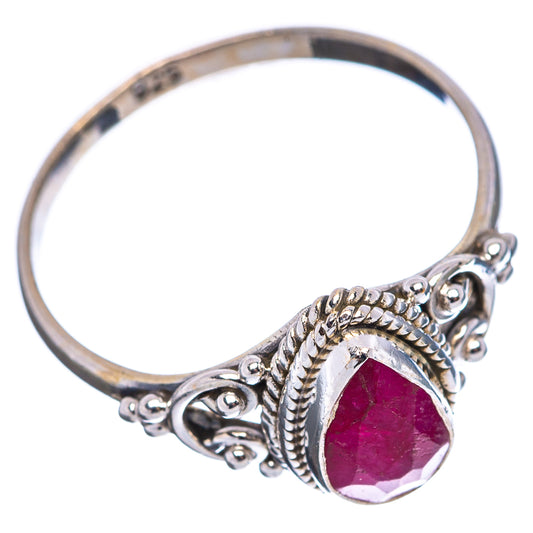 Sterling silver ring with oval red-pink gemstone bezel and decorative scroll band