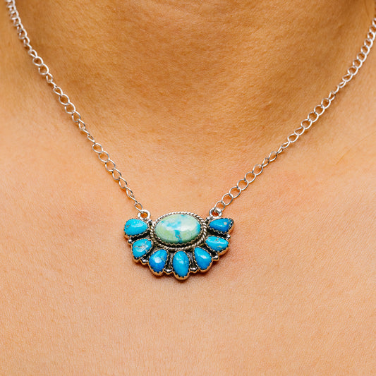 Turquoise pendant necklace with oval blue center and silver teardrop accents