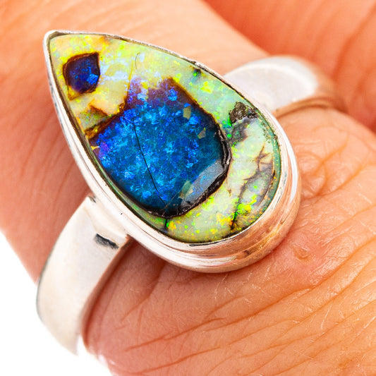 Sterling silver opal ring with oval blue-green cabochon, raised bezel, size 7