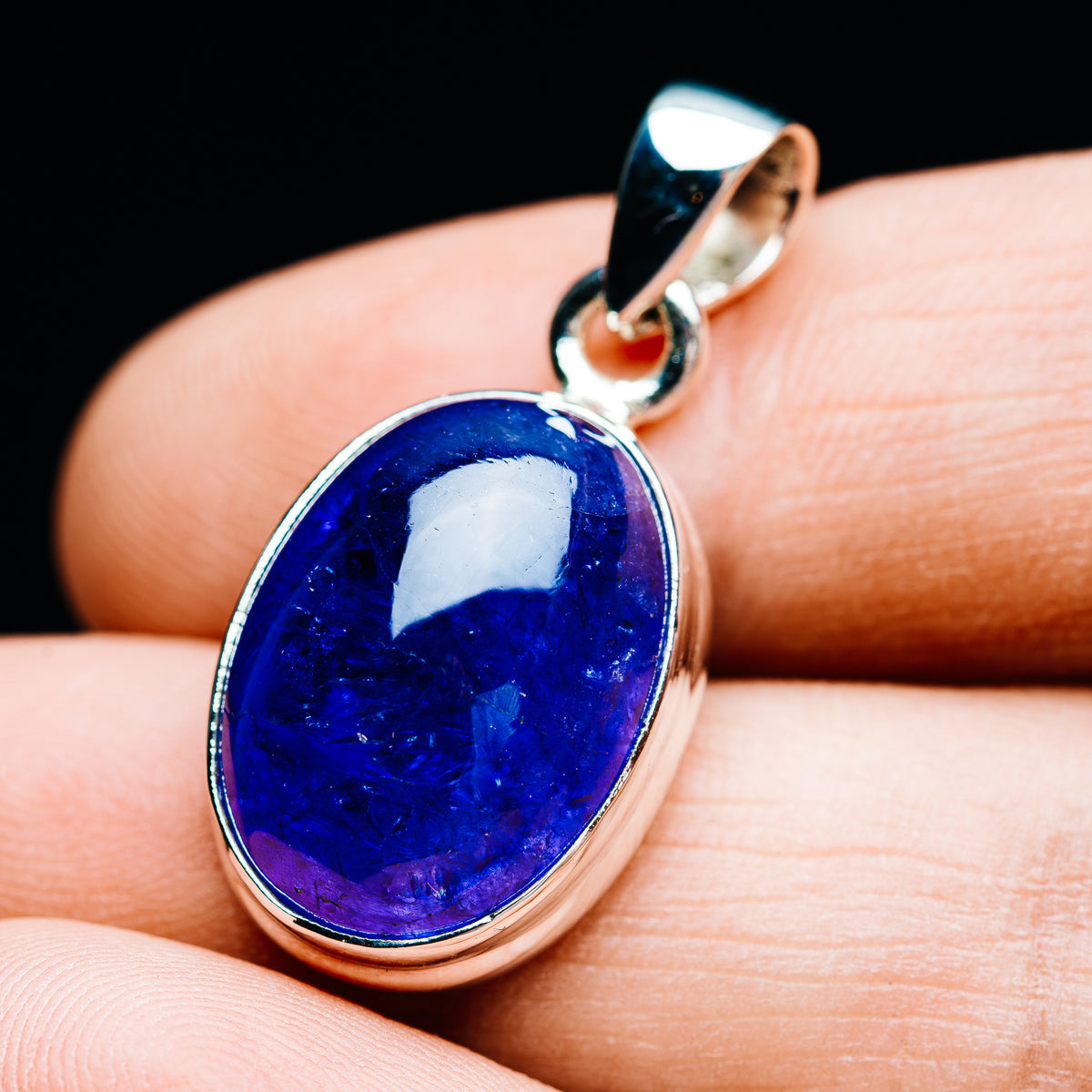 Oval blue gemstone pendant on 925 sterling silver bail, polished bezel setting.