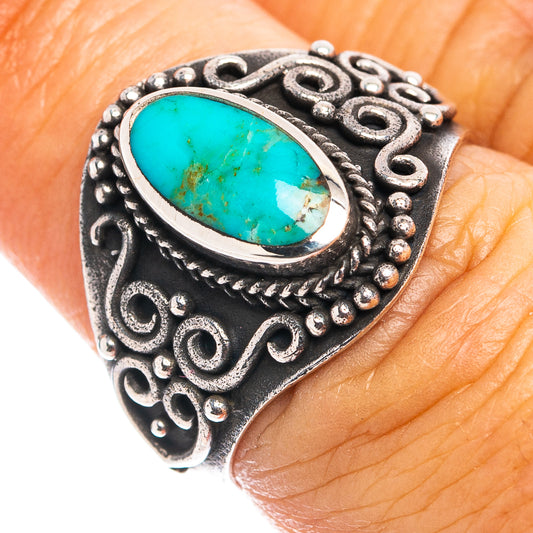 Turquoise oval cabochon sterling silver ring with ornate dark metalwork setting