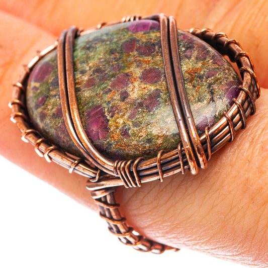 Oxidized copper oval fuchsite ring with purple-red speckled stone on wrist