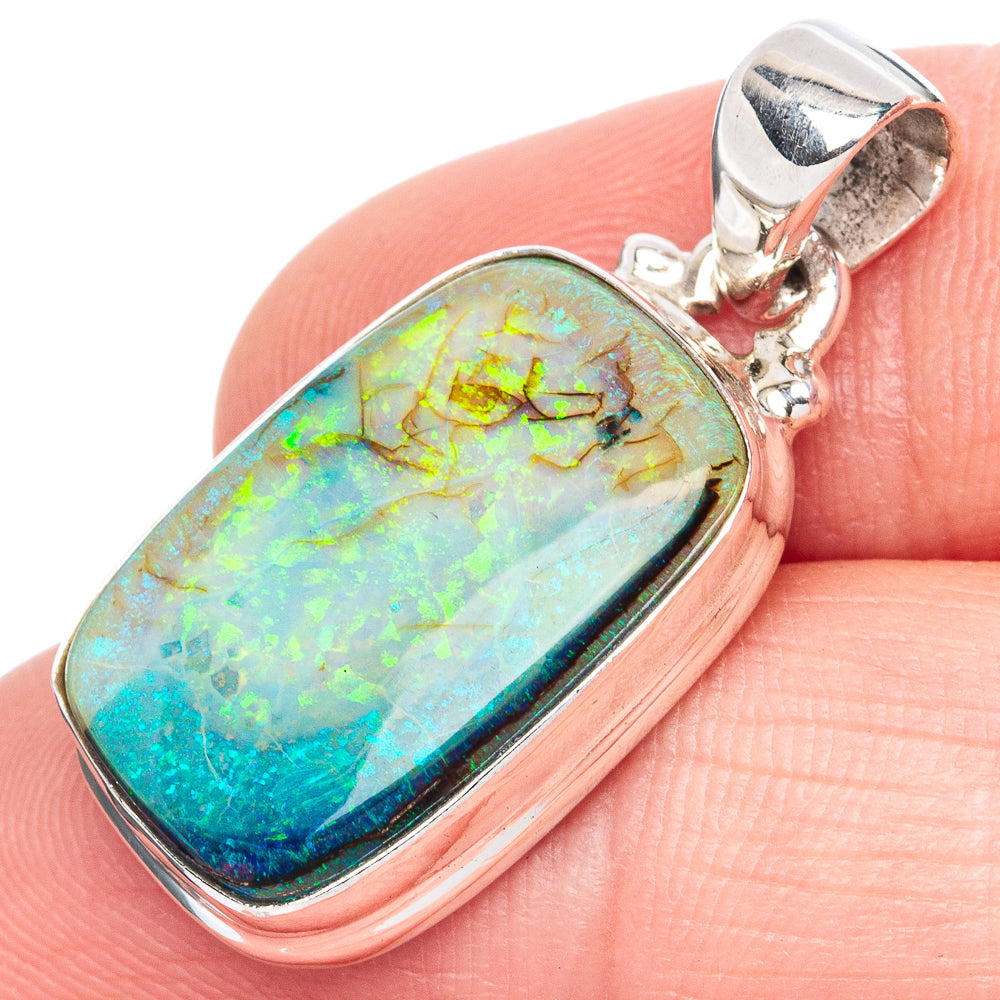 Oval opal pendant in sterling silver bezel with blue-green iridescence and hinged bail