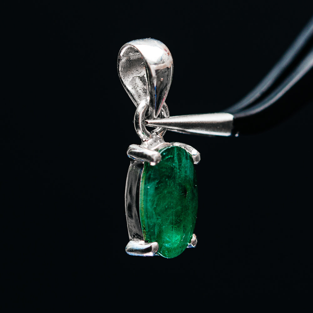 Green emerald pendant with oval faceted stone in .925 sterling silver, side view