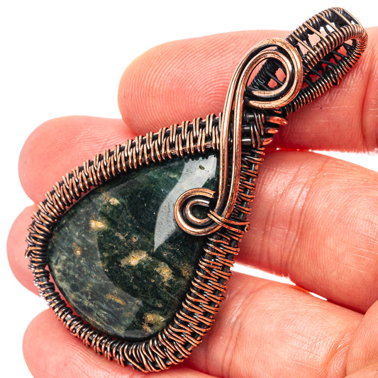 Ocean jasper teardrop pendant wrapped in oxidized copper wire, with loop bail