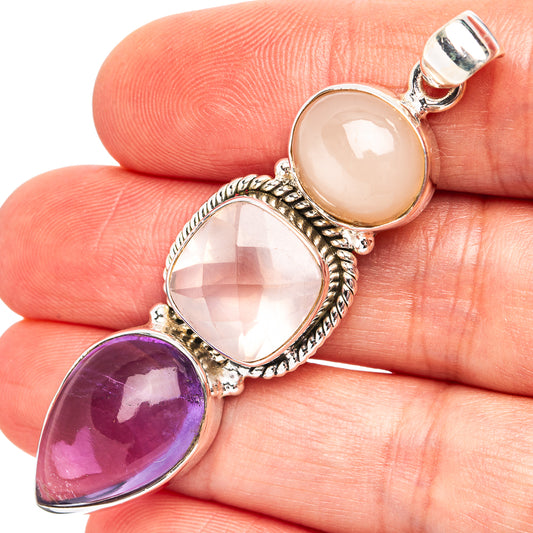 Sterling silver pendant with pink, purple, and peach teardrop gemstones, three-stone setting