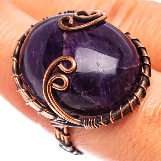 Oxidized copper wire wrap ring with large purple amethyst cabochon and swirl setting