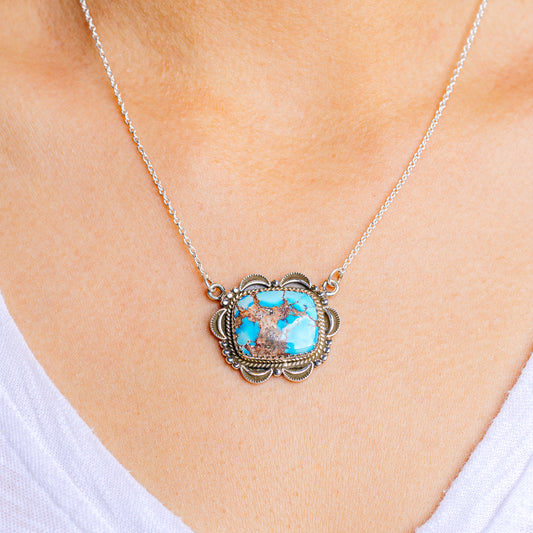 Turquoise pendant necklace with silver chain and ornate oval setting