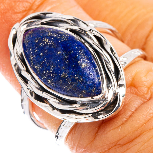 Sterling silver ring with oval lapis lazuli cabochon in swirling bezel